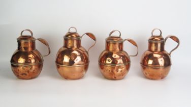 Ac set of four Victorian copper Jersey style jugs and covers, 22cm high. (4).