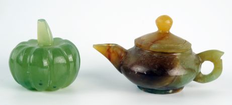 A polished jadeite miniature teapot and cover, 8cm long, together with a model of a pumpkin.