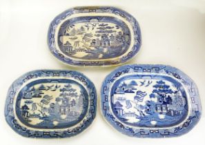 A group of three Staffordshire blue and white 'Willow' pattern meat plates, 39cm, 42cm and 46cm
