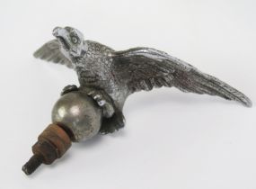 A chrome car mascot in the form of an eagle with spread wings, mounted on a ball finial, 18cm wide.