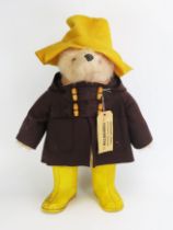 Gabrielle Designs Paddington Bear in brown coat, yellow hat and boots, with tag