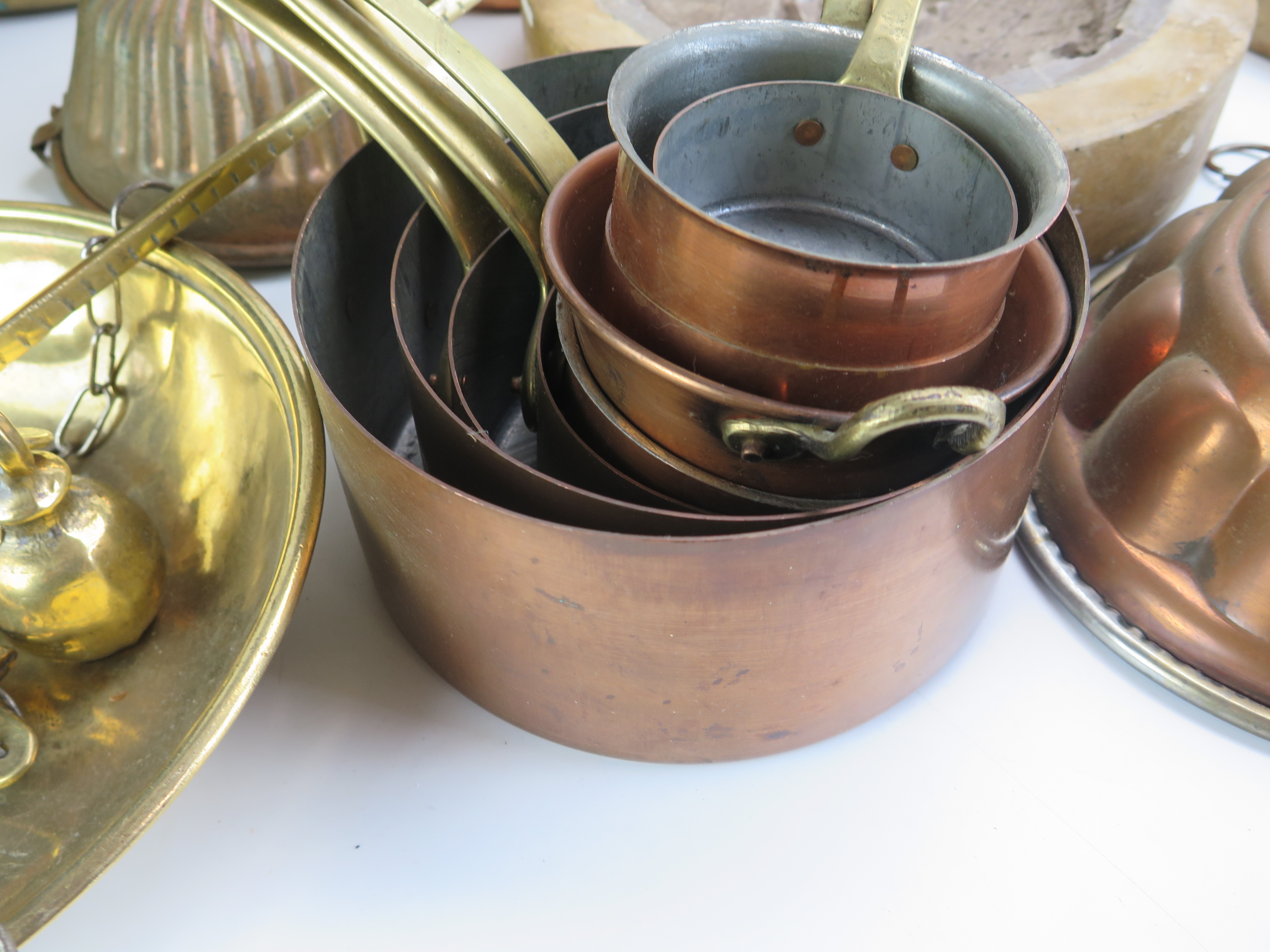 A collection of assorted kitchenalia, includes graduated saucepans, preserve pans, moulds, brass - Image 4 of 5