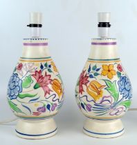 A pair of Poole pottery table lamps of ovoid form with painted floral decoration, overall height