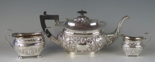 A matched three-piece barge-shaped silver tea service, various makers and dates, with gadrooned