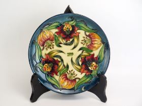 A Moorcroft pottery limited edition Year plate, '1999' designed by Nicola Slaney, No 647/750, 22cm