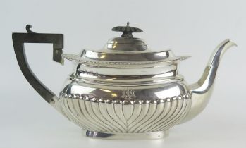 An Edward VII silver teapot, makers mark worn, Birmingham, 1906, monogrammed, of barge-shaped