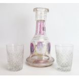 A continental clear glass decanter with painted floral decoration, together with two cut glass
