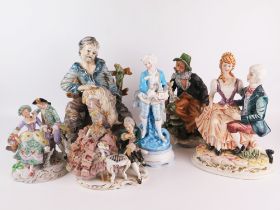 A Capo di Monte porcelain figure group of a seated tramp, 29cm high, together with five other
