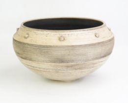 A large studio pottery bowl of flared circular form, with raised roundel and banded reeded