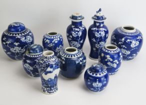 A collection of assorted Chinese prunus decorated ginger jars and covers, vase etc.