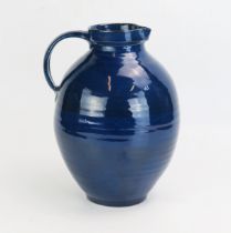 A Brannan ware pottery water jug, with dark blue glaze, impressed mark to the base, 28cm high.