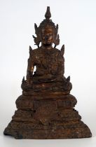 A gilt bronze figure of a Buddha, seated cross-legged on a lotus flower, 18cm high.
