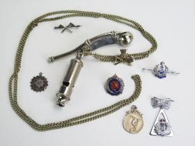 A plated bosun's whistle and chain, a 'Metropolitan whistle and assorted lapel badges.