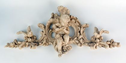 A composition pediment in the Italianate style, centred with a putti playing a flute, flanked by