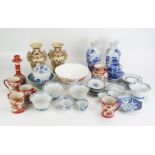 A collection of assorted Chinese and Japanese ceramics, including blue and white rice bowls and