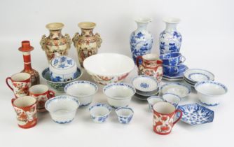 A collection of assorted Chinese and Japanese ceramics, including blue and white rice bowls and