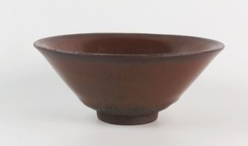 A Chinese provincial bowl with plain iron brown glaze on a circular foot, 11.5cm diameter.