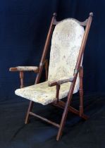 A Victorian walnut folding campaign chair, with padded back and seat, padded arm supports, on