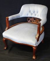 An Edwardian mahogany salon chair, with stuff-over rail back, with stuff over seat raised on swept