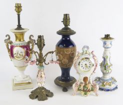 A Doulton vase converted to a table lamp, a pottery cased mantel timepiece and three other lamps. (