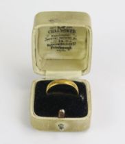 An Antique 22ct Gold Wedding Band with chased foliate scroll decoration, 4.5mm wide, size Q.75,