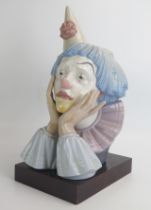 A Lladro figure 5129 Jester, wearing a coned hat, 31cm high.