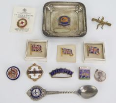 A collection of assorted enamel lapel badges, British Empire Exhibition ashtray, souvenir teaspoon