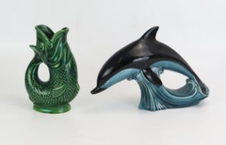 A Poole pottery model of a leaping dolphin, and a Dartmouth Pottery glug glug jug, 18cm high.