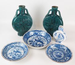 A pair of Chinese pottery moon flasks with loose foliate decoration to a blue/green ground,