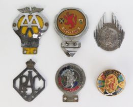 A collection of car badges including RAC , AA and Saint Christophers.