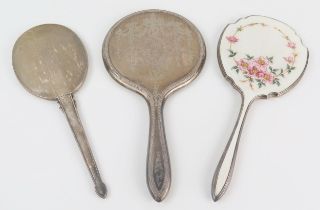 A silver and enamel backed hand mirror, together with two other silver backed hand mirrors. (3).