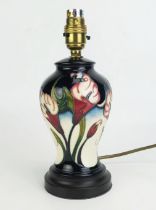 A Moorcroft pottery table lamp base, in the Calla Lily pattern, of baluster, on a stepped circular