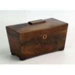 A 19th century mahogany tea caddy of sarcophagus outline with hinged lid, raised on squat bun