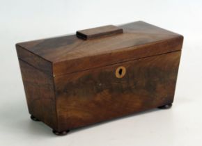 A 19th century mahogany tea caddy of sarcophagus outline with hinged lid, raised on squat bun