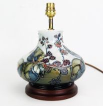 A Moorcroft pottery table lamp, in the Bramble pattern, of squat globular form, with tube-line