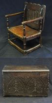 An antique small coffer, with a rectangular top, lunette carved front panel, with plain sides and