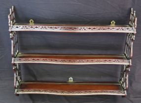A set of three 19th century mahogany wall shelves of serpentine outline, with fret carved sides,