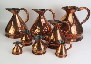 A collection of eight assorted 19th century copper measures, of traditional design. (8).