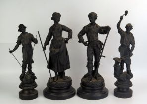 A pair of allegorical spelter figures depicting agriculture, mounted on ebonised circular bases,