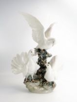 A large Lladro group of doves on a rocky outcrop, 51cm high. A/F