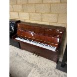 Petrof (c1997) An upright piano in a modern style bright mahogany case.