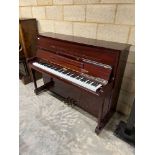 Kemble (c1992) An upright piano in a traditional bright mahogany case; together with a stool.