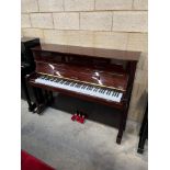 Kawai (c2007) A Model KX-15 upright piano in a bright mahogany case: together with a matching stool.