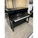 Essex (c2012) A Model 123 upright piano in a bright ebonised case.