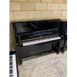 Boston (c2014) A Model 132 upright piano in a bright ebonised case.