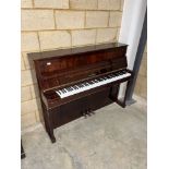 Schimmel (c1983) An upright piano in a mahogany 'classical' style traditional case; together with