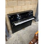 Yamaha (c1991) A Model 108 modern upright piano in a bright ebonised case; together with a