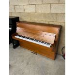 Streicher A recent Model UP108 upright piano in a cherrywood case.