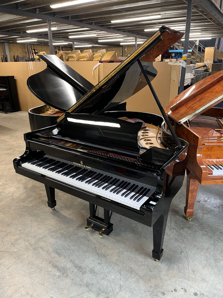 Steinway (c1958) A 5ft 7in Model M grand piano in a bright ebonised case on square tapered legs.