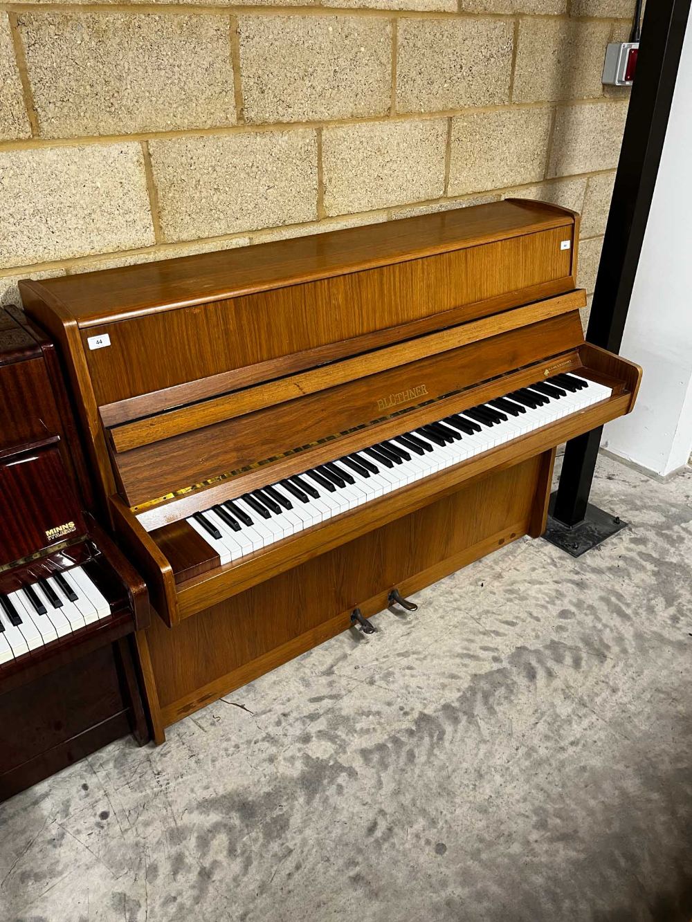 Blüthner (c1976) A Model 112 upright piano in a modern style walnut case.